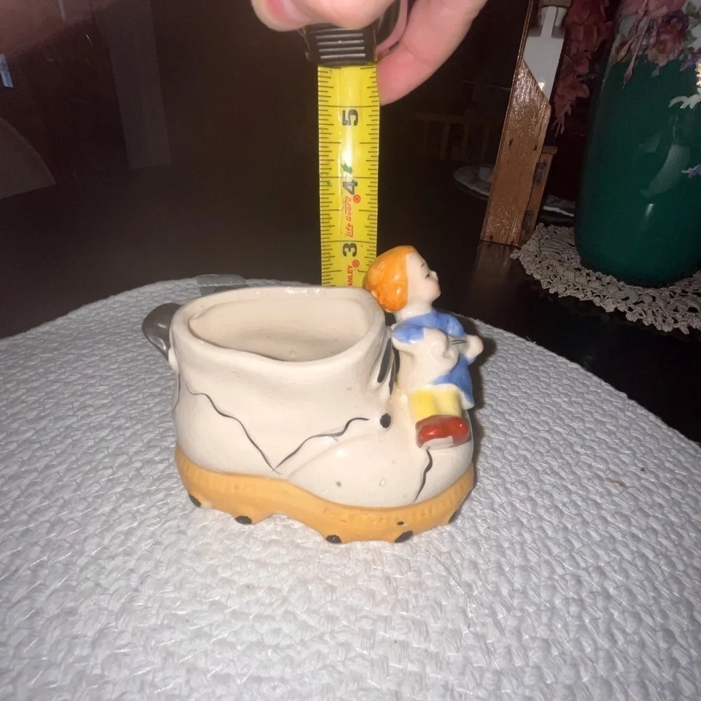 Vintage ceramic shoe with angel figurine planter
